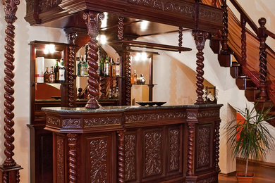 Seated home bar - large mediterranean single-wall medium tone wood floor seated home bar idea in Other with no sink, brown cabinets, granite countertops and wood backsplash