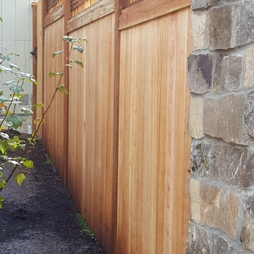 Cedar fence with stone columns and electric lanterns - before and after pictures