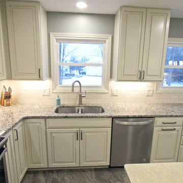 Beige Kitchen with Extra Large Island, Tile Backsplash and Granite Countertops