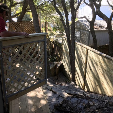 Lattice gate set in a aluminum frame alongside a lateral fence offset with 4by6s