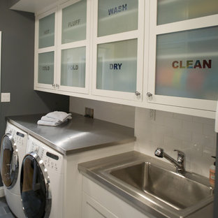 Inspiration for a traditional utility room in San Francisco with a built-in sink, glass-front cabinets and a side by side washer and dryer.