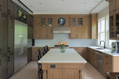 Inspiration for a large transitional u-shaped light wood floor and brown floor open concept kitchen remodel in Other with a single-bowl sink, raised-panel cabinets, light wood cabinets, marble countertops, white backsplash, marble backsplash, stainless steel appliances, an island and white countertops