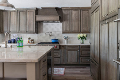 Eat-in kitchen - large traditional l-shaped eat-in kitchen idea in Sacramento with a single-bowl sink, raised-panel cabinets, green cabinets, quartzite countertops, porcelain backsplash, stainless steel appliances and an island