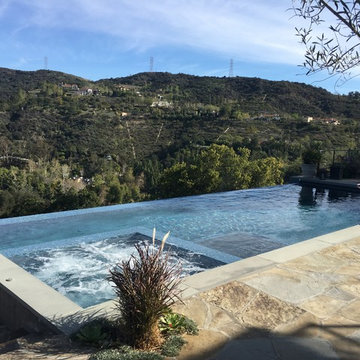 Infinity pool and spa with automatic pool cover