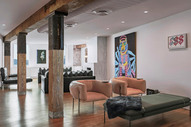 Living room - modern loft-style medium tone wood floor and exposed beam living room idea in New York with white walls, a standard fireplace, a stone fireplace and a wall-mounted tv