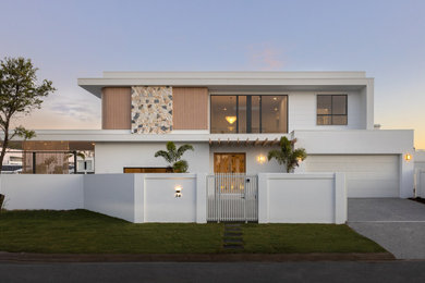 Design ideas for a contemporary two-storey white house exterior in Gold Coast - Tweed with a flat roof.