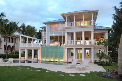 Beach style three-storey blue exterior in Miami.