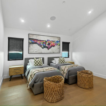 Twin Bedroom with Sloped Ceiling and Black Window Frames