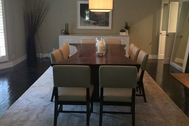 This is an example of an expansive beach style separate dining room in Los Angeles with beige walls and dark hardwood floors.