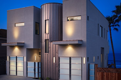 Example of a trendy gray two-story flat roof design in Santa Barbara