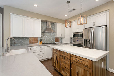 Eat-in kitchen - mid-sized transitional u-shaped medium tone wood floor and brown floor eat-in kitchen idea in San Diego with an undermount sink, shaker cabinets, white cabinets, quartz countertops, blue backsplash, porcelain backsplash, stainless steel appliances, an island and gray countertops