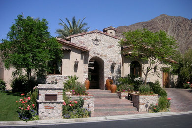Inspiration for a mid-sized southwestern gray one-story mixed siding exterior home remodel in Other with a tile roof