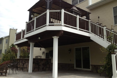 Design ideas for a large traditional backyard deck in New York with an awning.