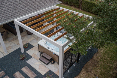 Patio - mid-sized contemporary backyard gravel patio idea in Houston with a pergola