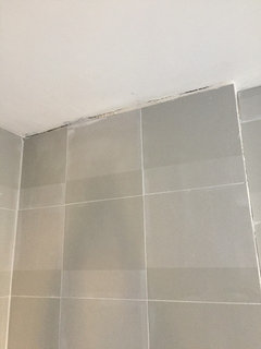 Tile uneven/sloped the wrong way- is there a quick fix so I put up a glass  wall? Do I just take my time a chisel the tile off and redo it? We