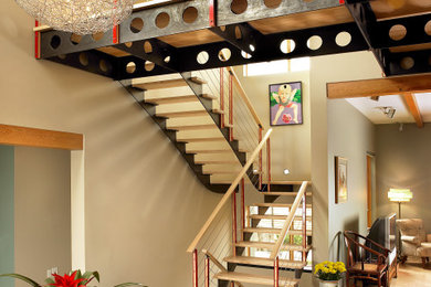 Inspiration for an industrial wooden straight open and cable railing staircase remodel in Toronto