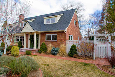 Design ideas for an expansive traditional two-storey brick beige exterior in Other.