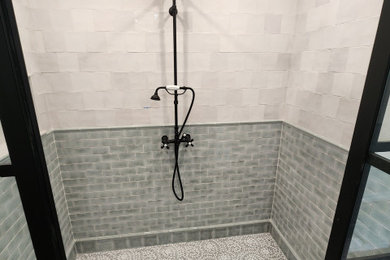 Bathroom - large country master white tile and ceramic tile wood-look tile floor, brown floor, double-sink, vaulted ceiling and wall paneling bathroom idea in Boston with furniture-like cabinets, green cabinets, a two-piece toilet, multicolored walls, a drop-in sink, marble countertops, a hinged shower door, white countertops, a niche and a built-in vanity