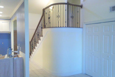 Staircase - large modern wooden curved mixed material railing staircase idea in Other with painted risers