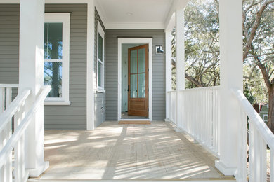 Mid-sized classic front porch idea in Charleston with decking and a roof extension