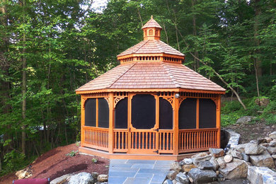 Patio - mid-sized traditional backyard stone patio idea in New York with a gazebo