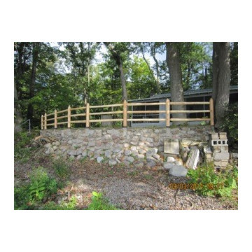 Cedar Post and Rail Fence Installed on a Retaining Wall