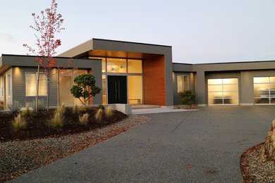 Inspiration for a mid-sized modern gray two-story wood exterior home remodel in Other