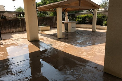 Patio - mid-sized modern backyard stamped concrete patio idea in Other with a pergola