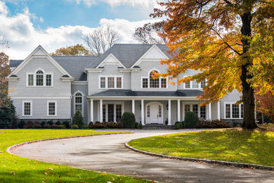 Inspiration for a timeless gray two-story house exterior remodel in New York with a shingle roof