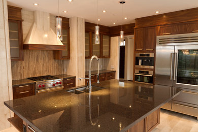 Mid-sized minimalist l-shaped ceramic tile and beige floor eat-in kitchen photo in Calgary with a double-bowl sink, shaker cabinets, dark wood cabinets, beige backsplash, marble backsplash, stainless steel appliances and an island
