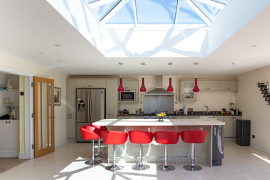 This is an example of a contemporary kitchen in Surrey with with island.