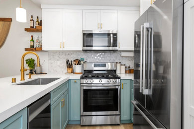 Eat-in kitchen - small traditional galley laminate floor and brown floor eat-in kitchen idea in Dallas with an undermount sink, shaker cabinets, green cabinets, quartz countertops, gray backsplash, mosaic tile backsplash, stainless steel appliances, a peninsula and white countertops
