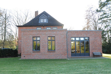 Elegant brick exterior home photo in Hamburg