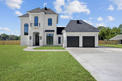 Example of a french country exterior home design in New Orleans