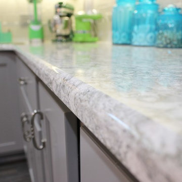 White Upper Cabinet and Gray Base Cabinet Kitchen With Quartz Counters
