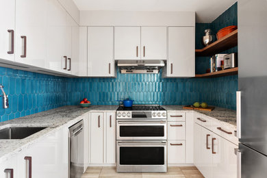 Inspiration for a small eclectic kitchen remodel in New York with flat-panel cabinets, quartz countertops, blue backsplash, ceramic backsplash and stainless steel appliances