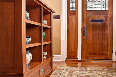 Entryway - mid-sized craftsman medium tone wood floor entryway idea in Charlotte with yellow walls