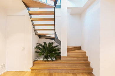 Example of a large trendy wooden u-shaped open staircase design in Turin