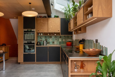This is an example of a medium sized contemporary l-shaped open plan kitchen in Other.