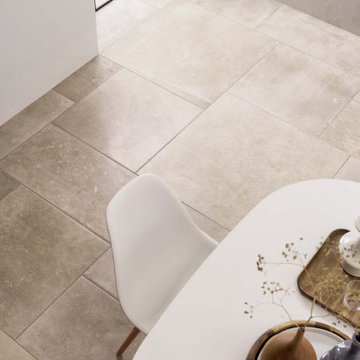 Contemporary dining area with beige stone look porcelain tile