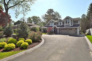 Example of a large transitional blue two-story mixed siding house exterior design in Toronto with a shingle roof