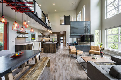 Example of a large minimalist open concept medium tone wood floor living room design in Other with gray walls, a two-sided fireplace and a wall-mounted tv