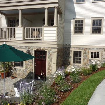 Cape Cod Inn with New England Stone Cladding, Retaining Walls, and Water Feature