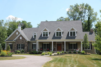 Inspiration for a large transitional beige two-story exterior home remodel in Cleveland with a shingle roof