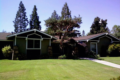 Example of a classic gray one-story wood exterior home design in Other with a clipped gable roof