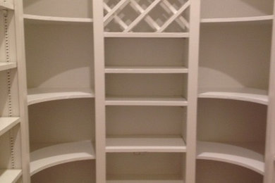Mid-sized trendy gender-neutral beige floor walk-in closet photo in Austin with open cabinets and white cabinets