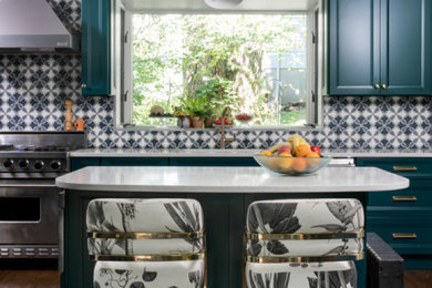 Eclectic kitchen photo in New York with shaker cabinets, stainless steel appliances, an island and white countertops