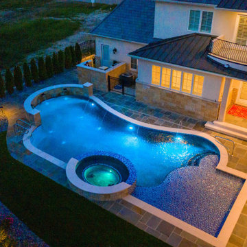 Naperville, IL freeform swimming pool with hot tub, large sunshelf, glass tile