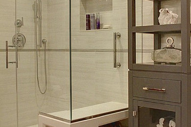Design ideas for a mid-sized modern bathroom in New York with an undermount sink, flat-panel cabinets, grey cabinets, engineered quartz benchtops, a corner shower, a one-piece toilet, gray tile, porcelain tile, grey walls and ceramic floors.