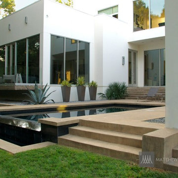 Modern Black Pool with Concrete Deck and Minimalist Planting